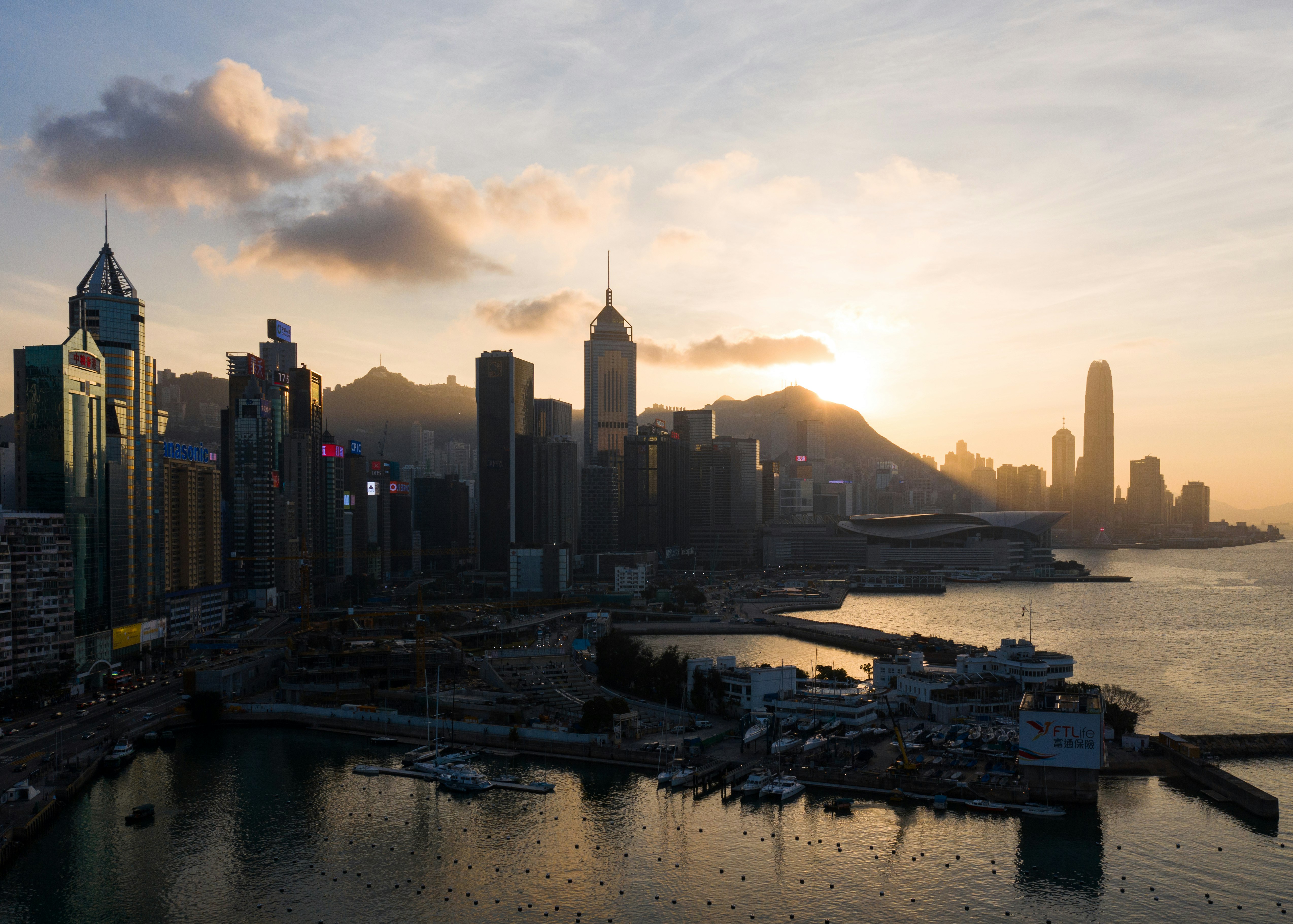 city skyline during sunset with body of water